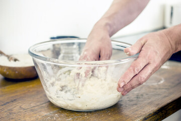 Obraz na płótnie Canvas Male hands kneading dough for bread