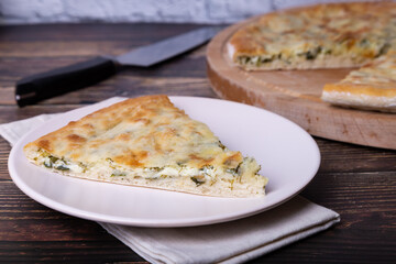 Ossetian pie with cheese and herbs (dill, parsley, scallion). Traditional Ossetian baking.