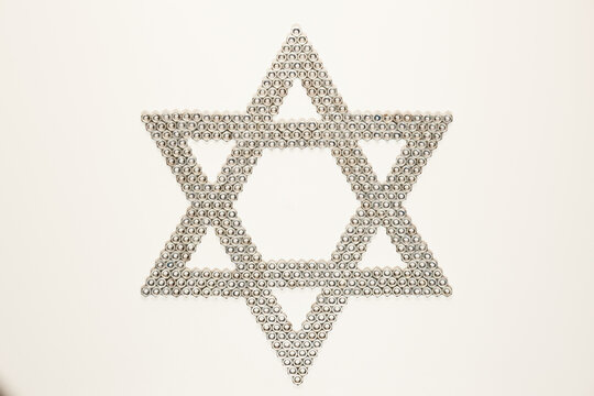 A Pattern Of The Star Of David Like A Metal Nuts Mosaic On The White Background. Top View