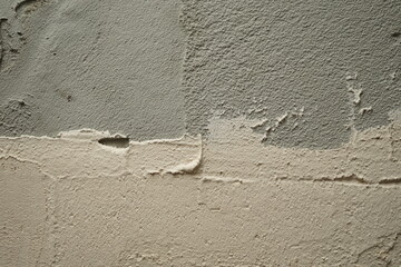 Textura of a rough cement surface. Grey and white plaster on the wall