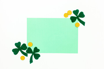 Composition for St. Patrick's Day. Decorating paper with green clover or shamrocks, gold coins and horseshoe.