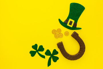 Composition for St. Patrick's Day. Decorating paper with green clover or shamrocks, leprechaun hat and horseshoe.