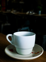 White cup of hot coffee on table