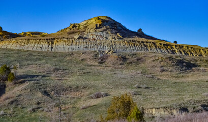 Geological stony-clay landscape, mountains and rocks in the evening at sunset. North Dakota