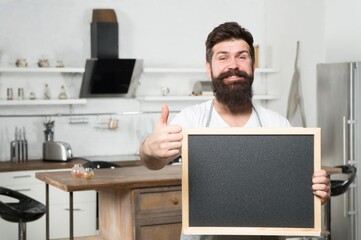 bearded hipster man hold chalkboard for copy space and show thumb up, promotion