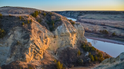View of the winding river from the mountain in the evening at sunset. North Dakota