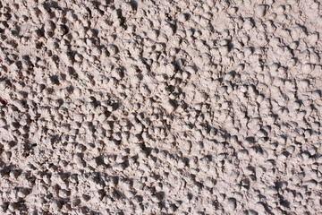 Expanded clay concrete texture. Light pink relief plaster, consisting of expanded clay stones. Abstract background.