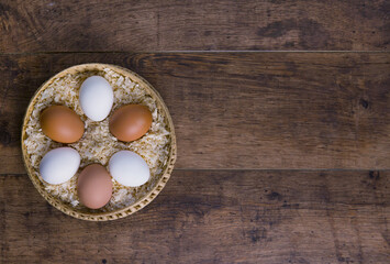 raw chicken eggs  in a basket