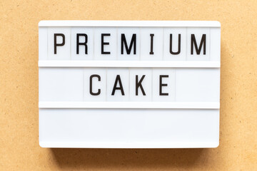 Lightbox with word premium cake on wood background