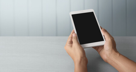 Hands holding  tablet touch computer gadget with  screen