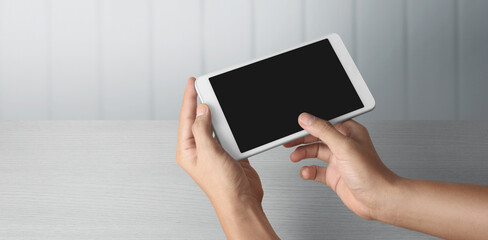 Hands holding  tablet touch computer gadget with  screen