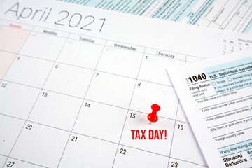 us individual income tax return 1040 form for 2020 with tax day text and red pin on april 15th on...