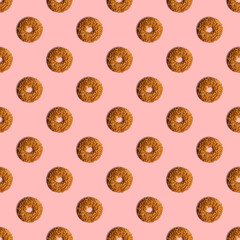 Fototapeta na wymiar Cookies template with sesame seeds on a pink background. View from above. Creative design, minimal flat lay concept.