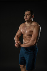 Fototapeta premium Man strains muscles naked torso Young male male businessman fashion, modern happy. Seller Studio, the success of elegance background black bodybuilder