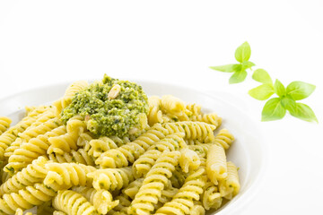 Pasta with pesto, basil leaves with white background