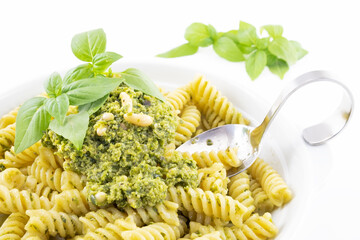 Pasta with pesto, basil leaves with white background