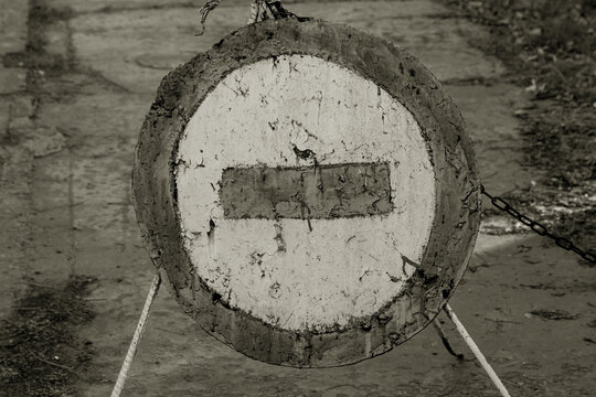 Old Cracked Shabby Road Sign Passage Closed. Brick Is A Road Sign That Blocks Passage On A Dangerous Closed Road. Symbolic Conceptual View Covering Any Forward Movement