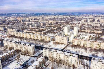 Fototapeta na wymiar Winter aerial view to residential area Saltivka in Kharkiv, Ukraine. Yuvilejnyj Avenue and microdistricts