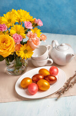 Easter table setting with easter eggs and spring flowers. Happy Easter.