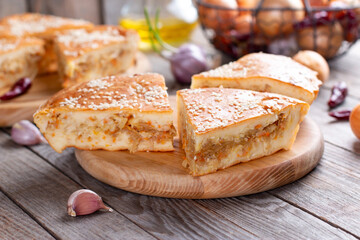Cabbage pie. Piece of tasty freshly baked homemade vegetable pie with cabbage and sesame seeds