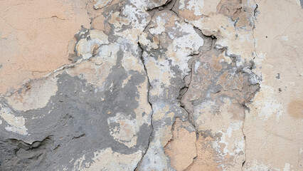 The old wall of the house. Crack. Plaster.