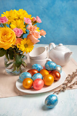Easter table setting with easter eggs and spring flowers. Happy Easter.