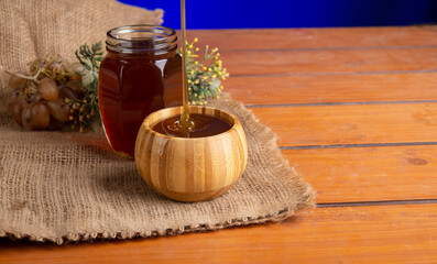 Natural honey jar on kitchen assorted table top view