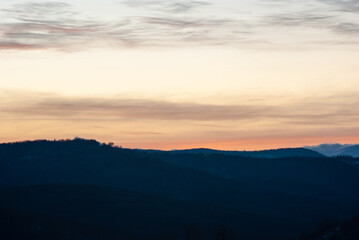 Silhouette of hills and forest at sunset
