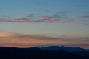 Silhouette of hills and forest at sunset