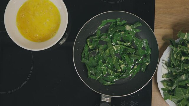 Chef making an omellet with spinach