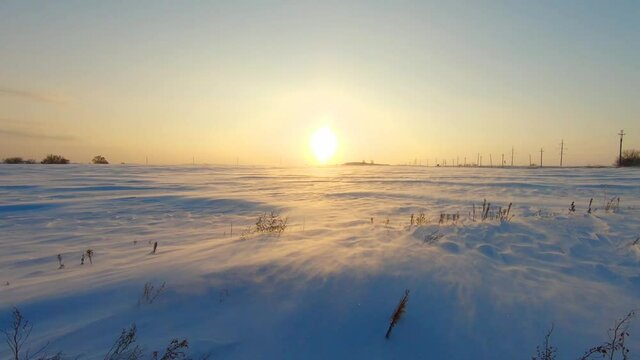 Arctic snow storm at sunset. Polar snow drifting storm and blizzard. Extreme Temperature.