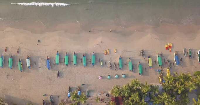 Row Of Boats InThe Shore Of Palolem Beach, Canacona, South Goa, India. - aerial ascend, top down