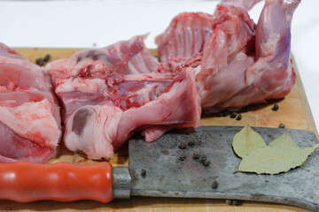 Rabbit pieces and meat chopper. Dietary meat.
