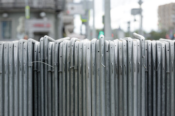 Temporary fence. Metal sections of temporary fencing, portable pedestrian barrier assembled and...