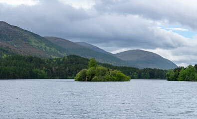 Fototapeta premium Panoramic image of Loch an Eilein Castle, old castle of the Wolf of Badenoch on an island , located in the middle of the Loch an Eilein