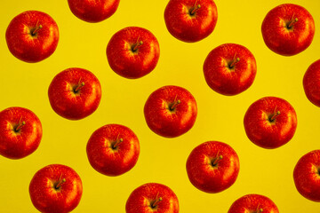 pattern of red apples on a bright yellow background with trendy sunlight