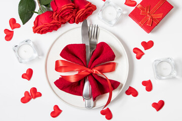 Valentine's day romantic dinner concept. Beautiful table setting. Roses and candles on a white background.
