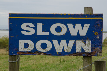 Sign to alert the driver to slow down. Waihola. Otago. South Island. New Zealand.