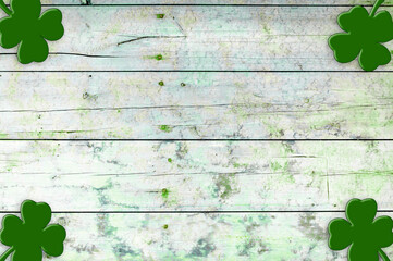 Fototapeta St Patricks day background. Shamrocks over a light green wood background obraz