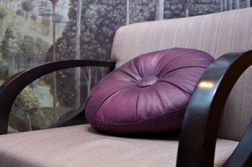 Armchair with round pillow inside cabin stateroom on modern luxury cruiseship or cruise ship liner
