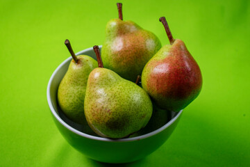 bright and fresh pears on green background