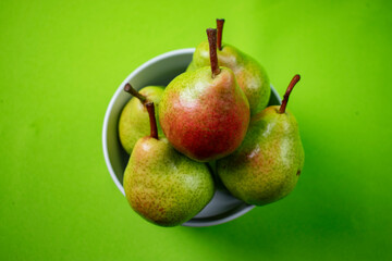 bright and fresh pears on green background