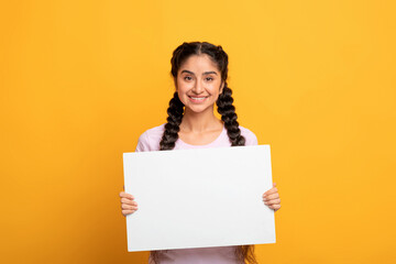 Indian woman holding blank white advertising board