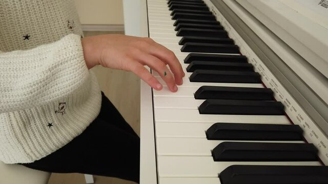 little pianist. the Pretty Girl is at home taking piano lessons. tiny fingers and musical notes