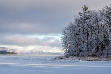 Early morning winter scene with ice vapor on the lake