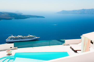 White architecture and blue sea on Santorini island, Greece. Luxury swimming pool with sea view. Famous travel destination