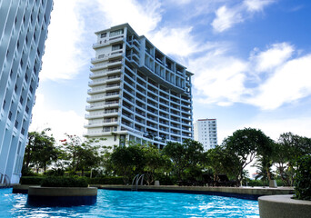 Fototapeta na wymiar The high rise building view from the swimming pool