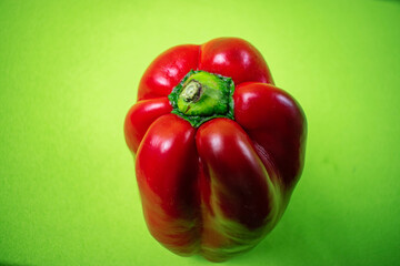 bright red pepper on green background
