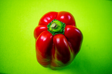 bright red pepper on green background