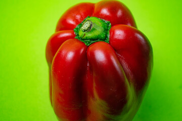 bright red pepper on green background